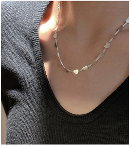 Close-up of S925 sterling silver heart-shaped sequins necklace on model's neck
