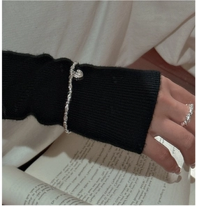Close-up of S925 sterling silver beaded bracelet with heart charm and textured ring