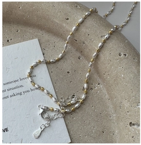 Macro detail of S925 sterling silver beaded necklace with mixed gold and silver tones