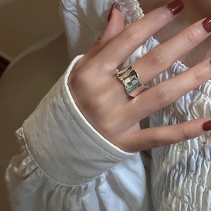 Minimalist S925 sterling silver ring with irregular wave texture on a female hand