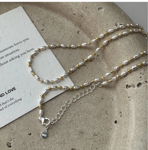 Detail of S925 sterling silver necklace with mixed gold and silver textured beads