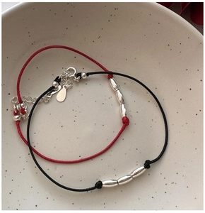 Detail of red and black s925 silver bead bracelets with adjustable lobster clasp links