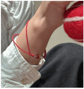 Close-up of s925 silver bamboo-style red rope bracelet with a round carnelian bead