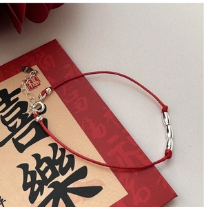Detail of red cord bracelet with S925 silver beads and adjustable spring clasp closure