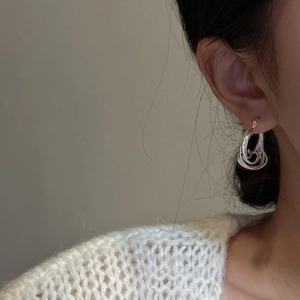 S925 sterling silver triple spiral earrings with retro textured finish on female model