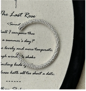 Detail of S925 silver beaded wrap bracelet on vintage linen fabric with poem text