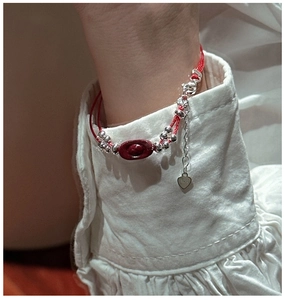 Close-up of S925 sterling silver red rope bracelet with cinnabar ingot on model's wrist
