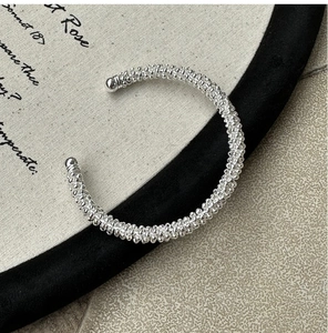 Close-up of S925 sterling silver cuff bracelet with vintage beaded texture and sphere ends