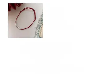 Detail view of s925 silver square beads on an adjustable 16cm minimalist red woven bracelet