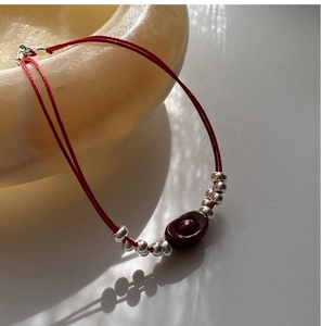Detailed close-up of S925 silver red string bracelet with cinnabar ingot charm and beads