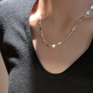 Minimalist S925 sterling silver necklace featuring delicate heart pendants on model