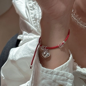 Minimalist S925 sterling silver red cord bracelet with heart pendant on wrist