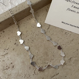Minimalist S925 sterling silver heart link necklace on a grey stone aesthetic background