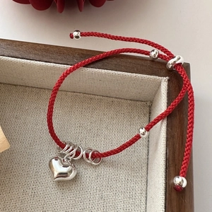 Minimalist red cord bracelet with S925 sterling silver heart charm and adjustable clasp