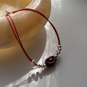 S925 sterling silver red string bracelet with cinnabar sycee charm in soft natural light