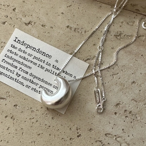Minimalist S925 sterling silver hollow moon pendant necklace on textured stone