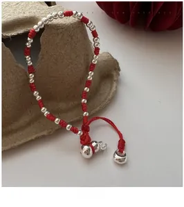 Gros plan du bracelet en corde tressée rouge avec billes en argent S925 et gourde