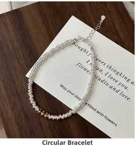 Detail of S925 sterling silver coiled wire bracelet with vintage gold beads and lobster clasp