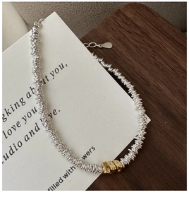 Detail of S925 sterling silver coil bracelet with gold square beads and extension chain