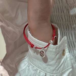 S925 silver red string bracelet with Good Luck charm and silver beads on a wrist