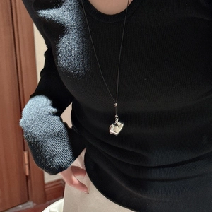 S925 silver minimalist 3D heart pendant on black cord necklace worn by a model
