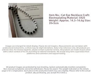 Close-up of S925 silver necklace featuring brushed metal beads and cat eye stone