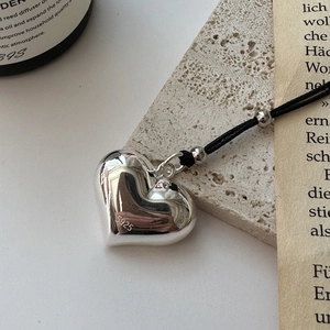 Minimalist S925 sterling silver heart pendant necklace on a black braided rope cord