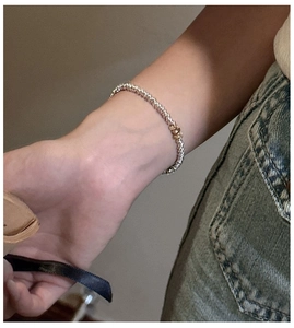 Detailed shot of minimalist S925 sterling silver beaded bracelet with gold contrast beads