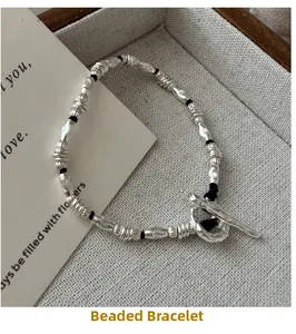 Detail of S925 silver beaded bracelet with textured metal beads and vintage OT clasp