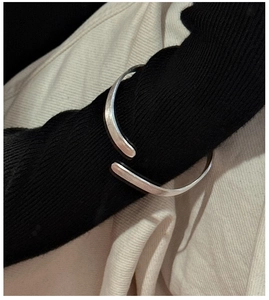 Detail of S925 sterling silver wave texture open bangle with a brushed matte finish