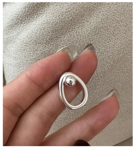 Detailed view of S925 sterling silver minimalist earring with oval frame and small silver ball
