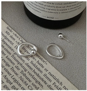 Macro shot of S925 sterling silver ball earrings and hoop set with metallic finish