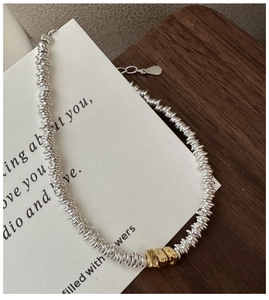 Detail of S925 silver bracelet featuring mixed gold irregular rings and lobster clasp