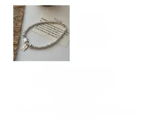 Detailed view of S925 sterling silver cat and fish charm bracelet with smile tag