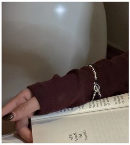 Macro shot of silver CNC bead chain bracelet featuring a vintage minimalist toggle clasp
