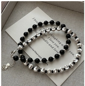 Detailed view of S925 sterling silver beaded bracelet set with textured metal finish