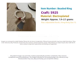 Detailed view of S925 sterling silver beaded ring featuring red agate bead and pendant