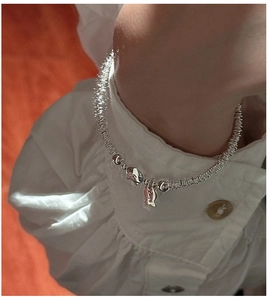 Detailed shot of S925 sterling silver beaded bracelet with fish charm and Smile engraving