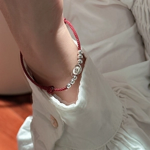 Minimalist S925 sterling silver red rope bracelet with silver sycee charm on a wrist
