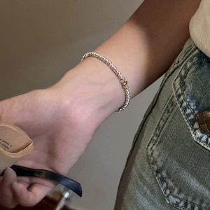 Minimalist S925 sterling silver beaded bracelet with gold and silver color accents on wrist