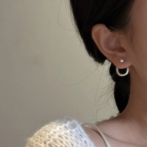 Elegant S925 sterling silver split ball hoop earrings worn with white knit sweater