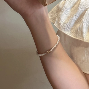 Minimalist S925 sterling silver beaded bracelet with a single gold square charm on wrist