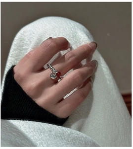 Close-up of S925 silver beaded ring with red agate accent and hollow oval pendant