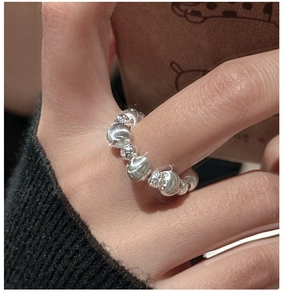 Detail of 925 sterling silver beaded ring on model holding a coffee cup