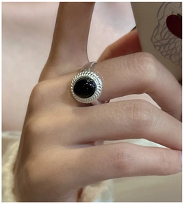 Macro view of vintage 925 sterling silver ring with round black onyx and rope edge detail
