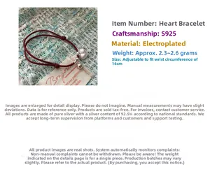 Detail view of S925 sterling silver heart charm and red braided string bracelet