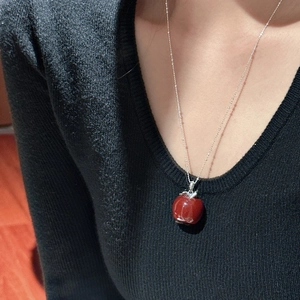 S925 silver red apple pendant necklace worn on a black knit sweater for a stylish look