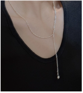 Y-shaped S925 silver beaded tassel necklace worn on a black knit sweater