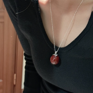 Minimalist S925 sterling silver red apple pendant necklace worn on a black sweater