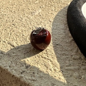 Minimalist S925 silver necklace featuring a deep red glazed apple pendant on stone